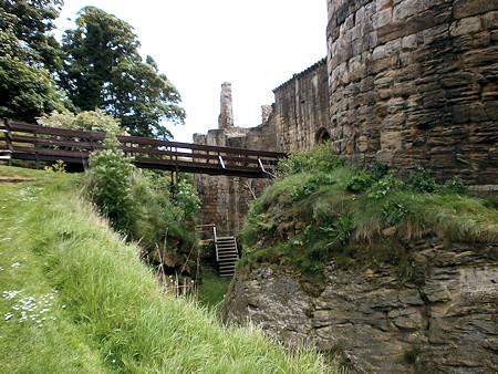 Looking along the ditch at the foot of the west tower. The entrance bridge is visible in the centre.